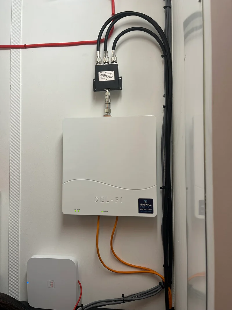 a photograph of a white wall mounted on a wall with wires and wires