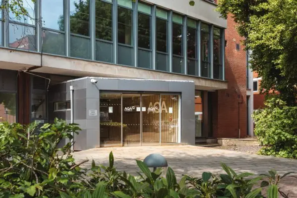 a photograph of a building with a glass front door and a glass front door
