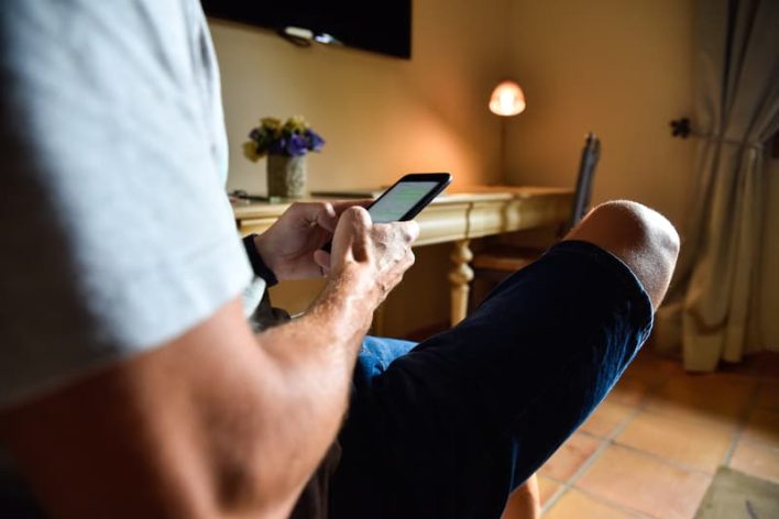 Man-Mobile-Phone-Hotel-Room Man-Mobile-Phone-Hotel-Room